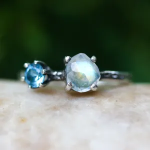 Faceted moonstone ring in silver bezel setting and blue topaz on the side with sterling silver band
