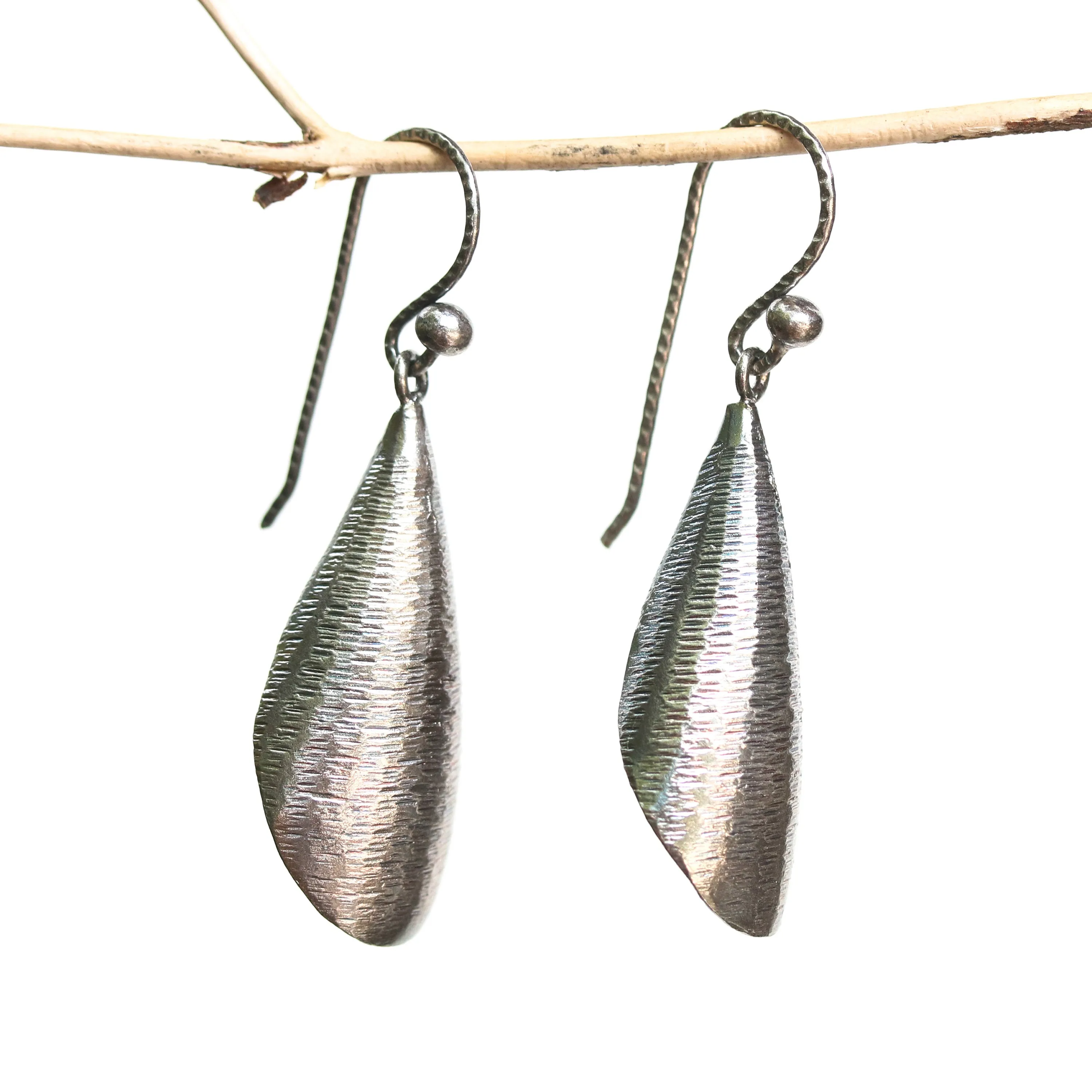 Silver leaf shape earrings with textured on oxidized sterling silver hooks style