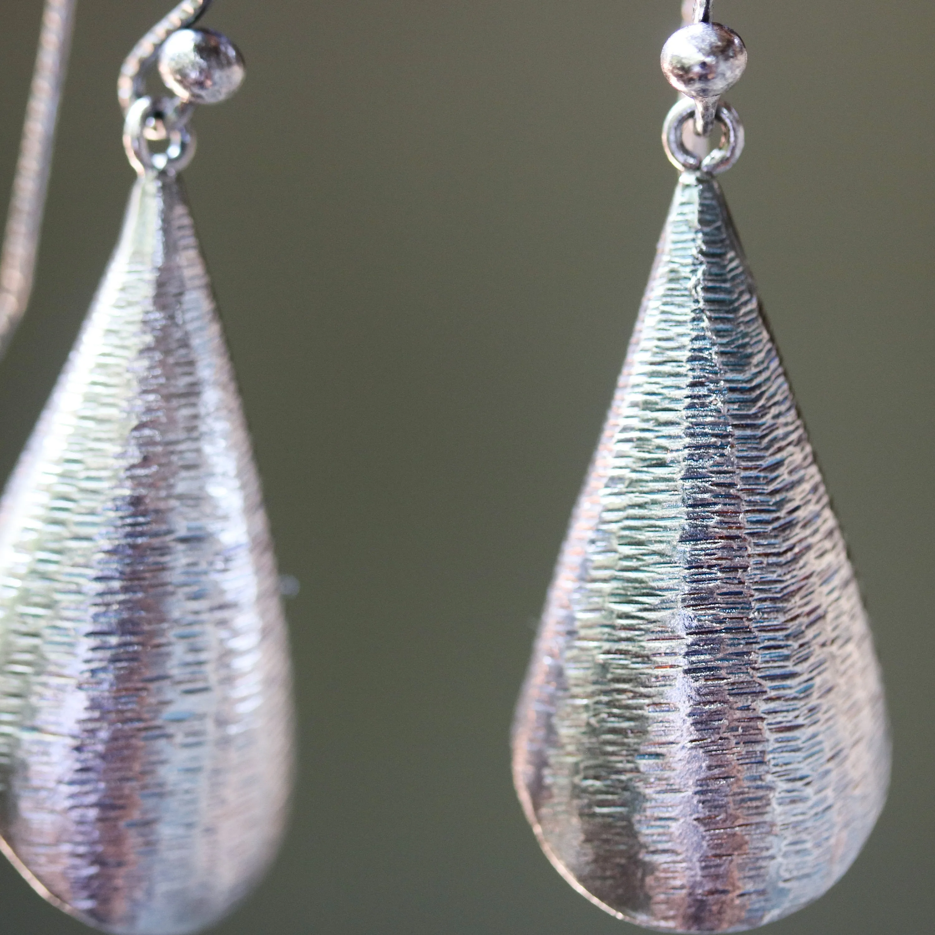 Silver leaf shape earrings with textured on oxidized sterling silver hooks style