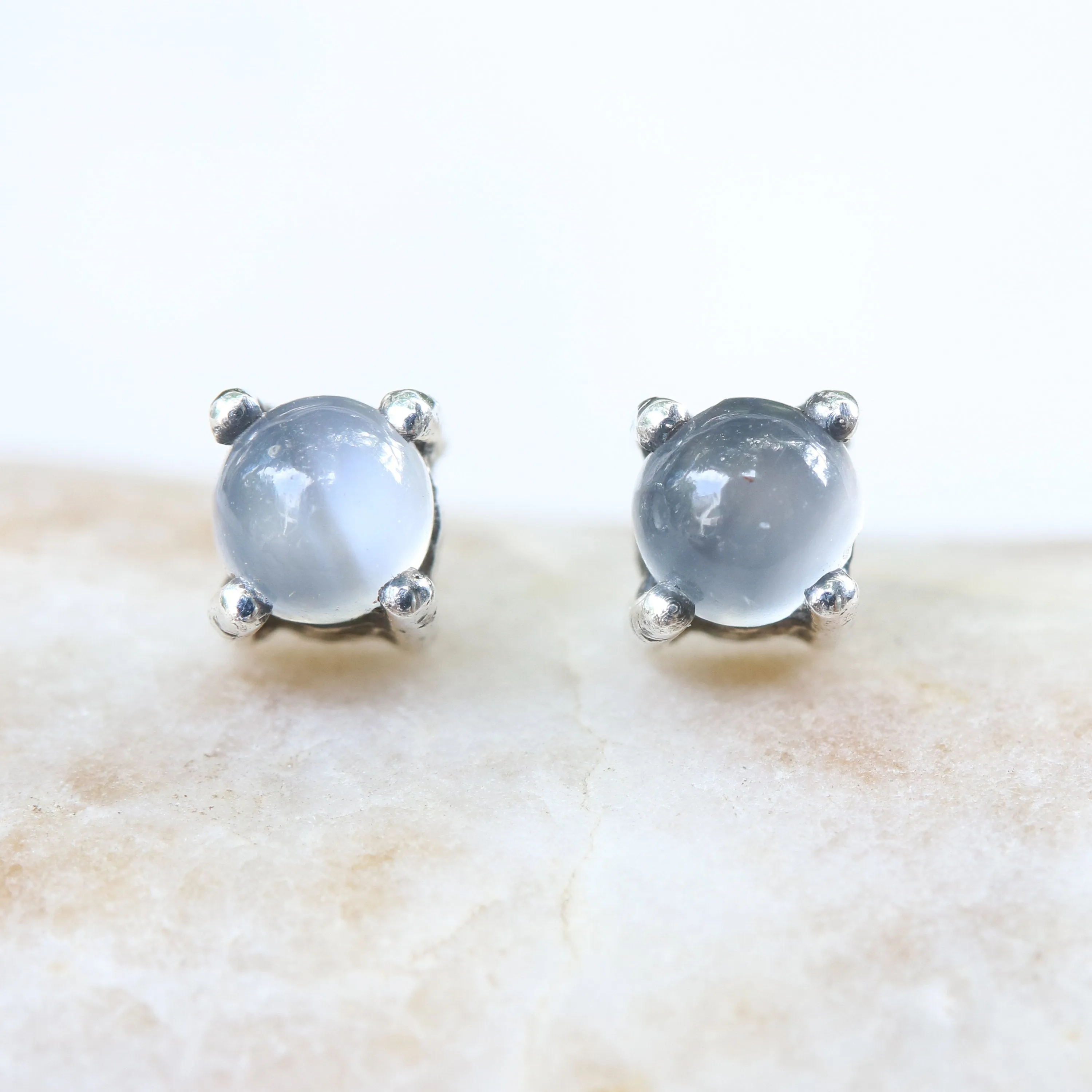 Sterling silver stud earrings with cabochon white moonstone in prongs setting with sterling silver post and backing