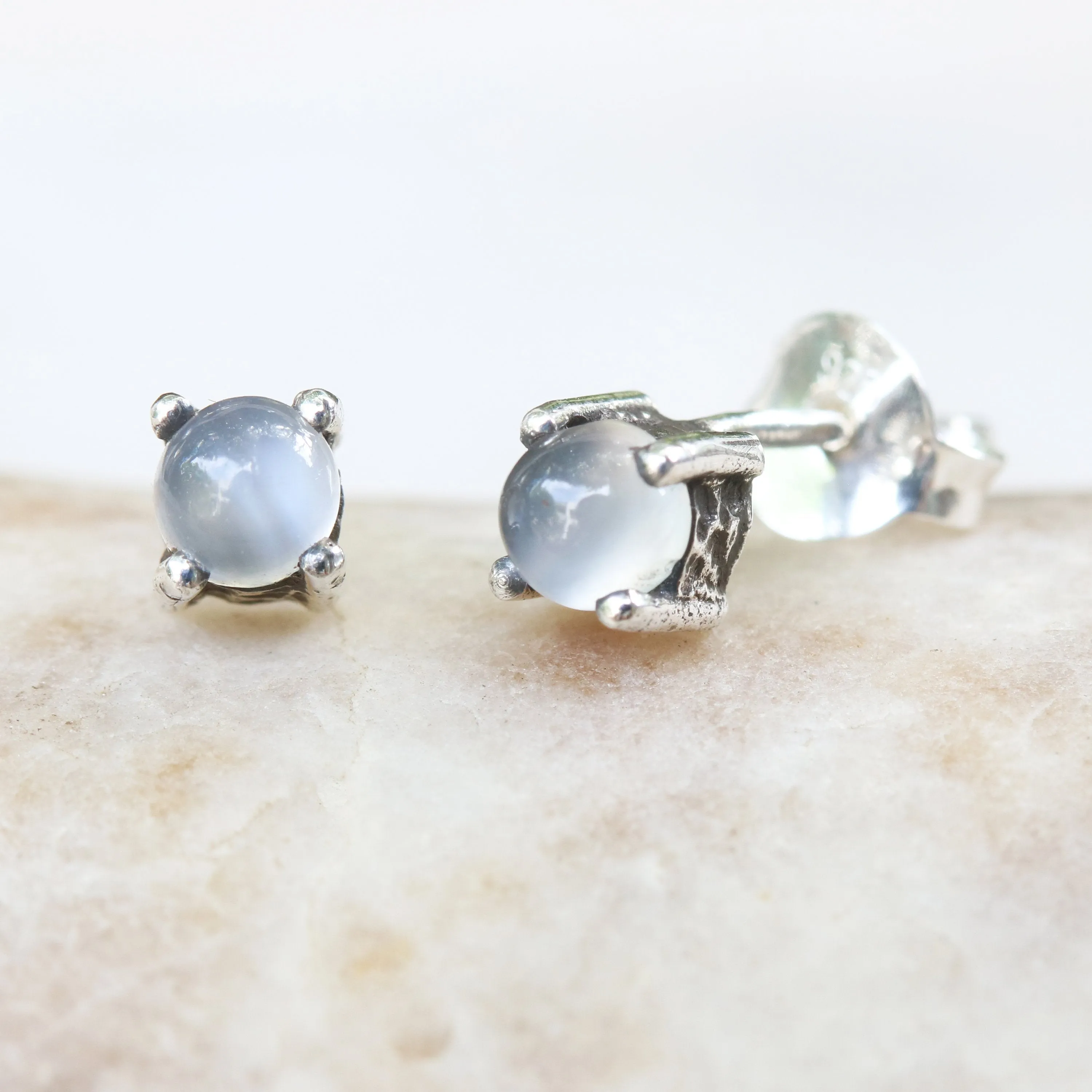 Sterling silver stud earrings with cabochon white moonstone in prongs setting with sterling silver post and backing
