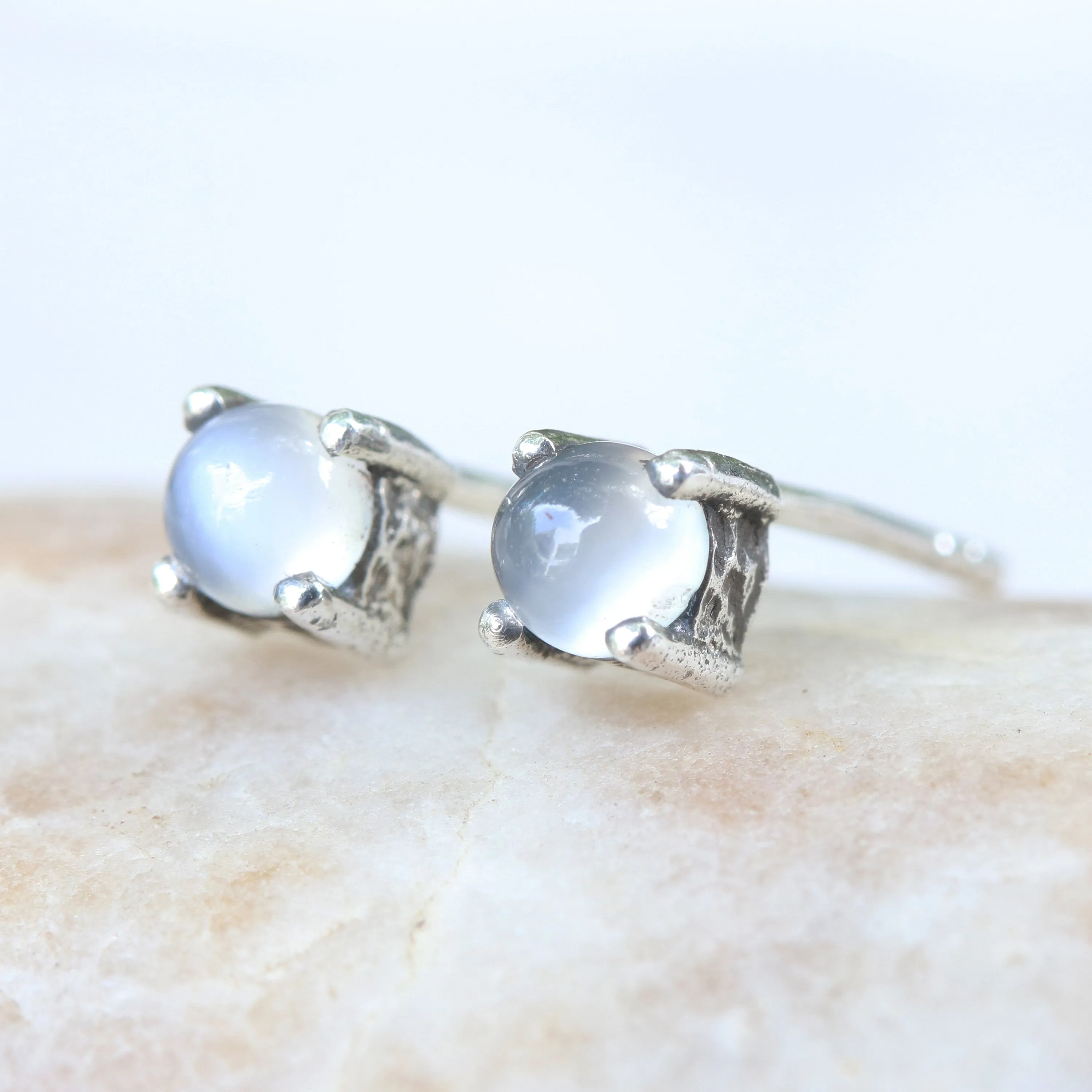 Sterling silver stud earrings with cabochon white moonstone in prongs setting with sterling silver post and backing