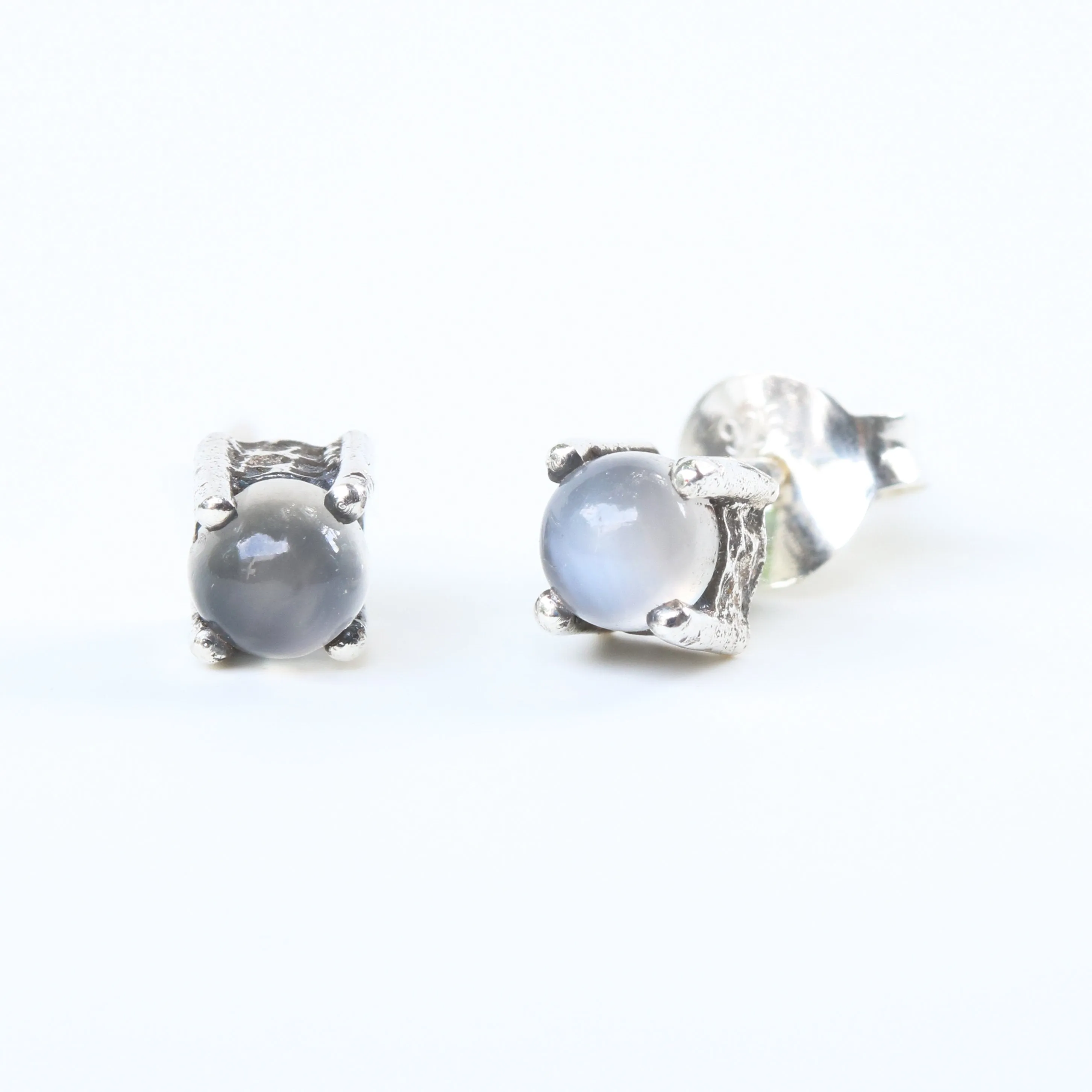 Sterling silver stud earrings with cabochon white moonstone in prongs setting with sterling silver post and backing
